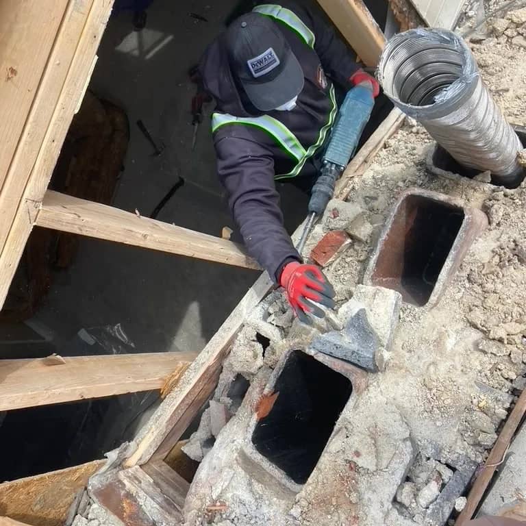 Experienced demolition crew performing controlled interior tear-out with safety equipment and precision