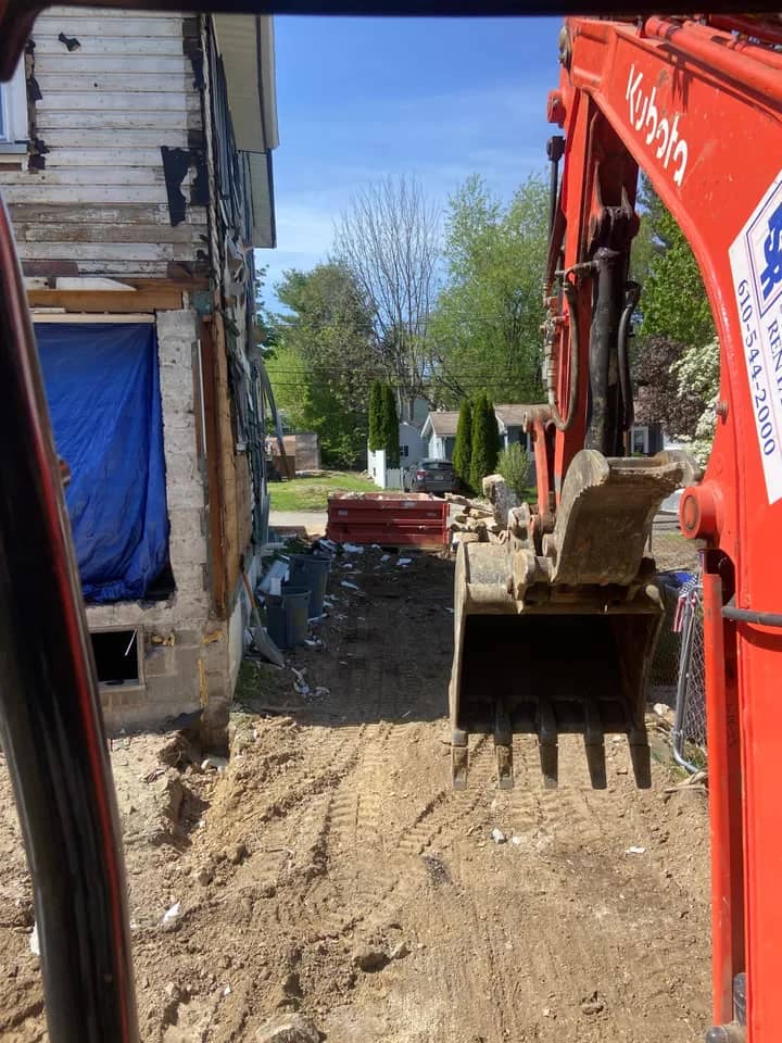 Demolition team reviewing teardown plan and equipment placement on active site