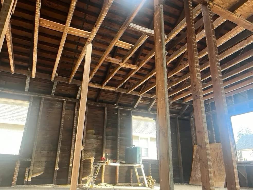 Experienced demolition crew using specialized equipment for controlled structural removal on site