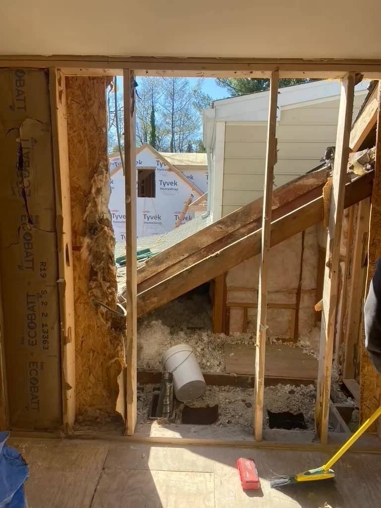 Demolition crew removing detached garage materials before residential rebuild begins