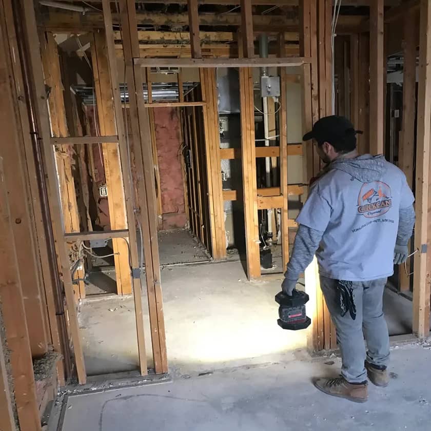 Skilled demolition professionals performing controlled removal inside commercial building with precision tools