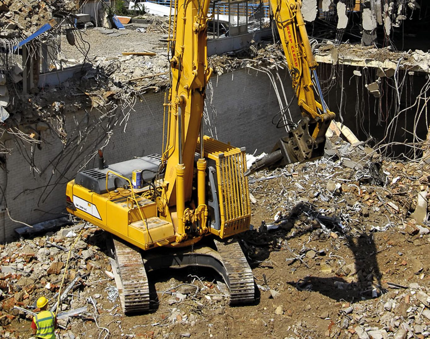 Experienced demolition crew using specialized equipment for controlled structural removal on site