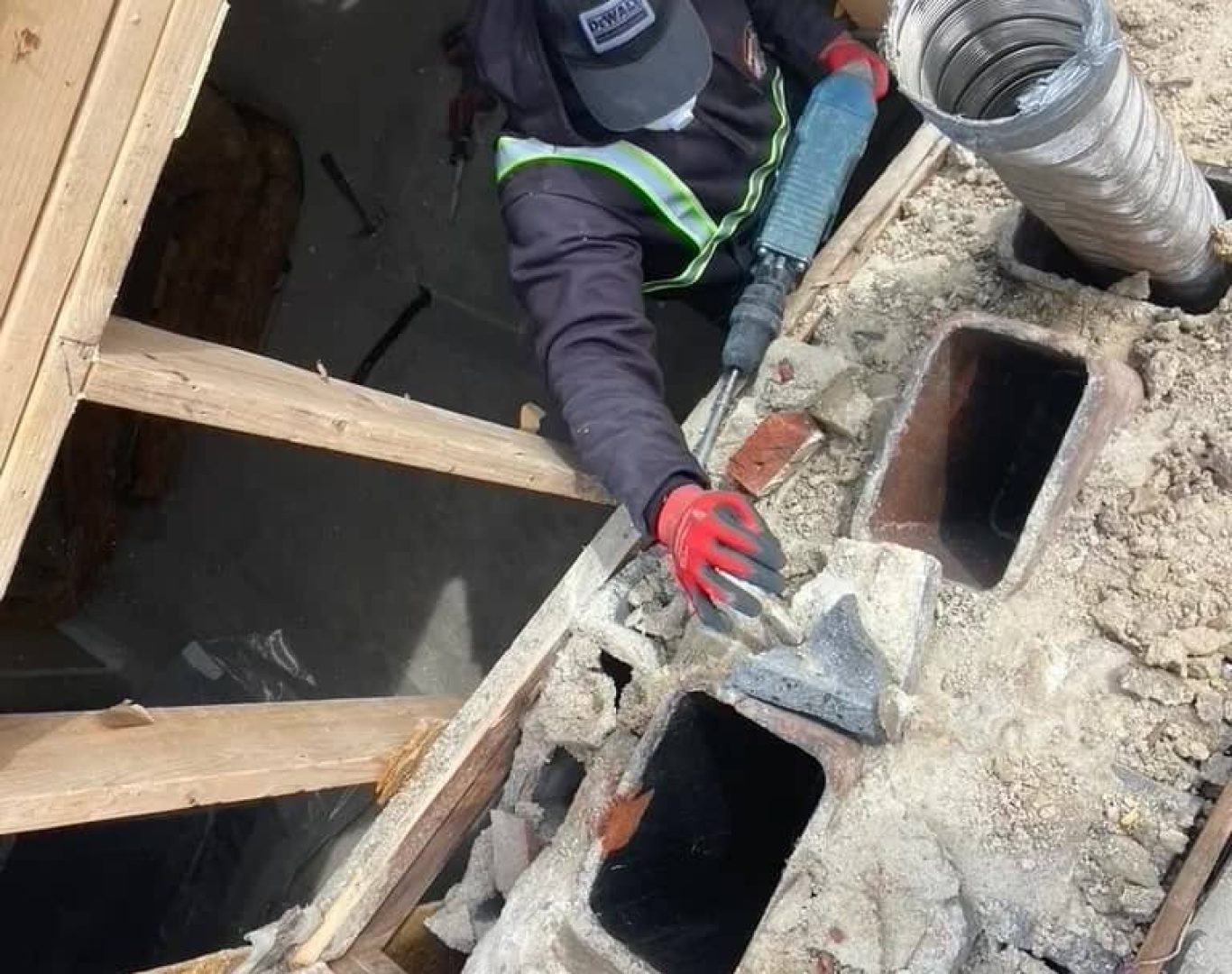 Experienced demolition crew performing controlled interior tear-out with safety equipment and precision