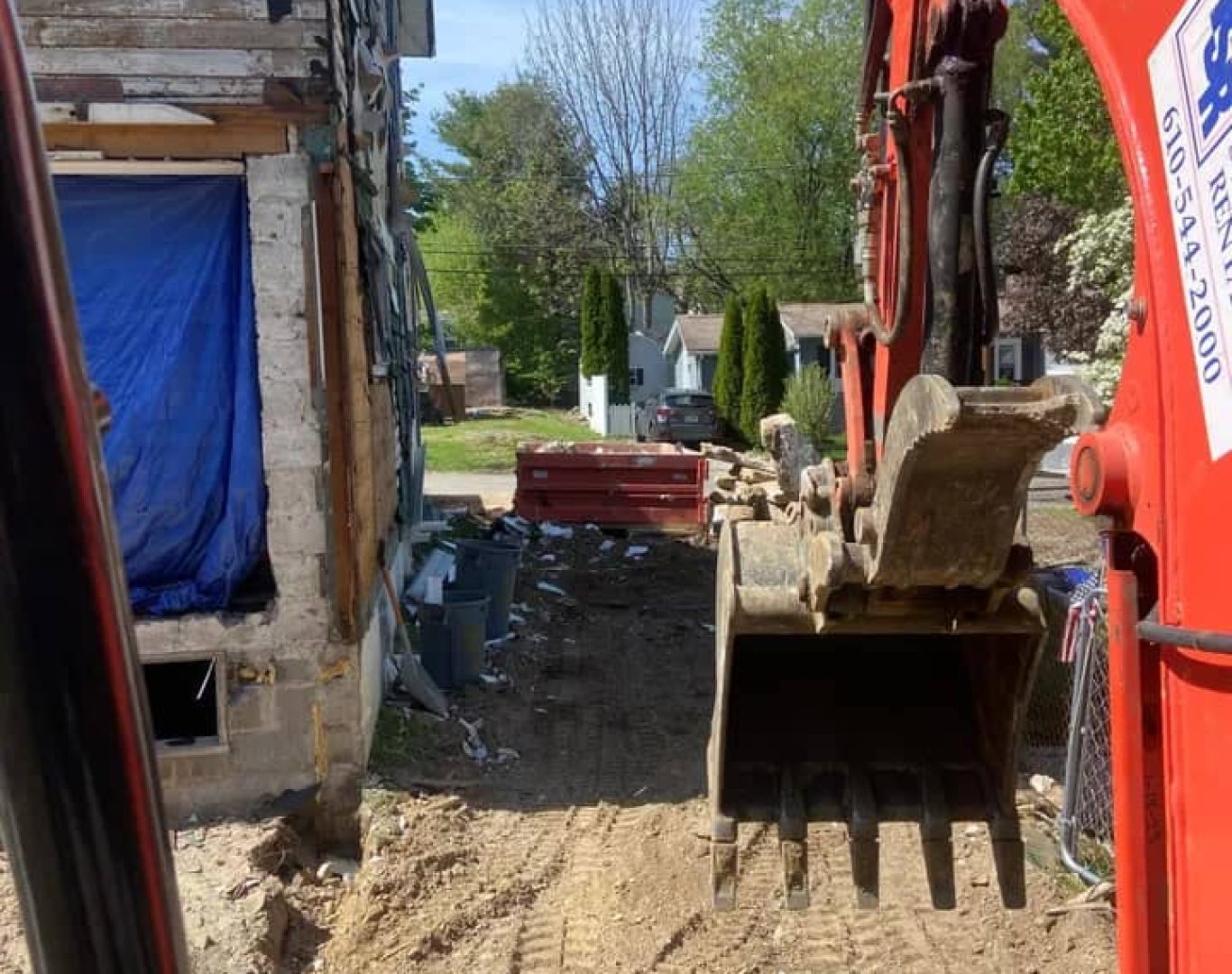 Demolition team reviewing teardown plan and equipment placement on active site