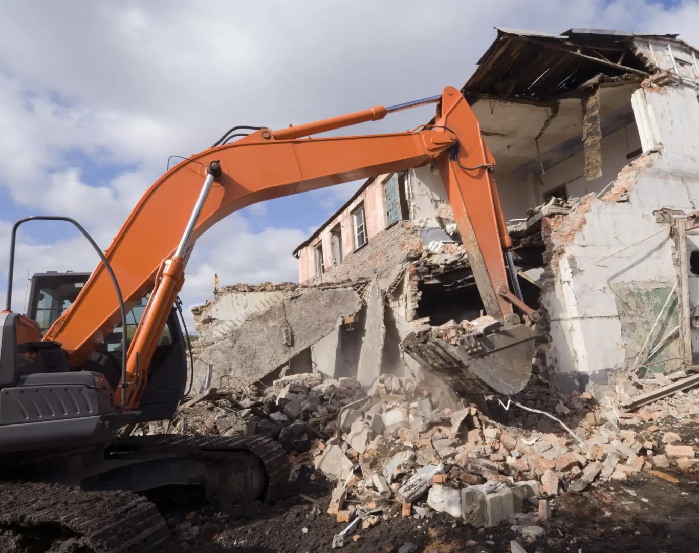 Experienced demolition crew using specialized equipment for controlled structural removal on site