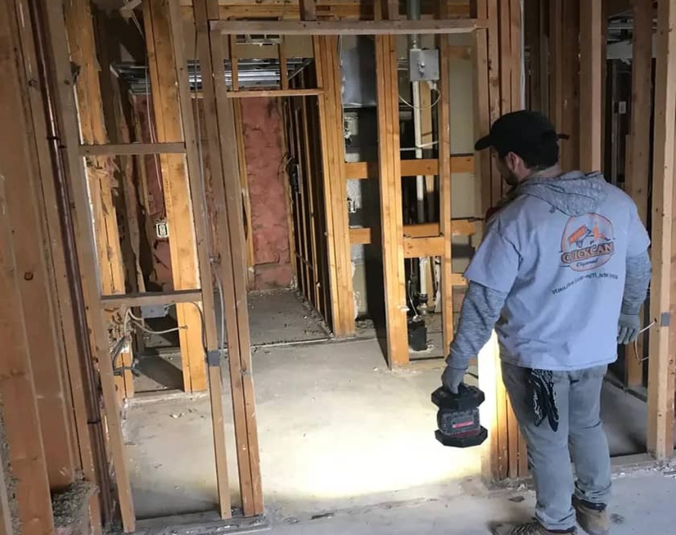 Skilled demolition professionals performing controlled removal inside commercial building with precision tools